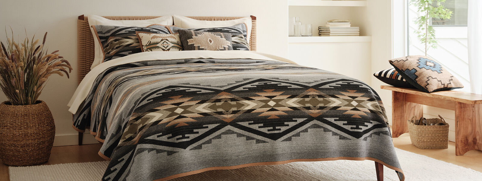 Geometric Pendleton blanket on a bed in a light cozy room
