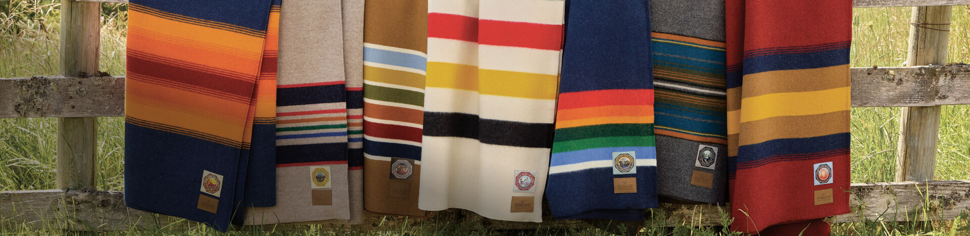 Pendleton blankets draped over a weathered fence
