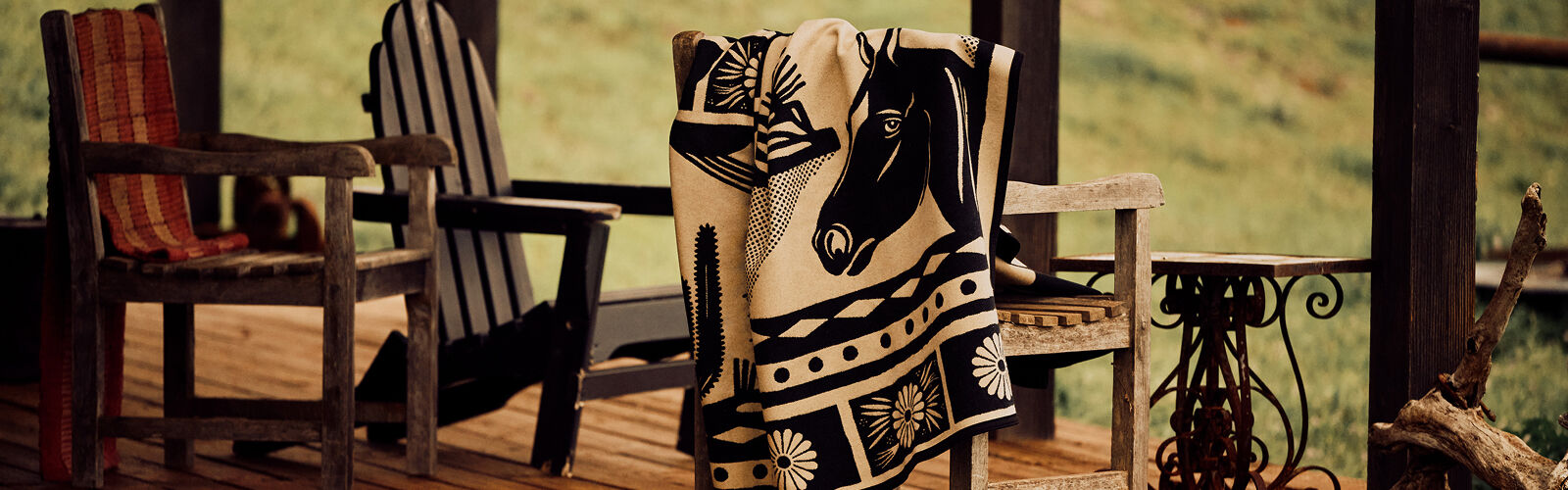 Saratoga blanket draped over a chair on a front porch
