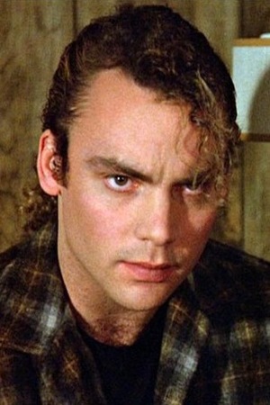 Eric Dare as leo in a plaid Pendleton shirt.