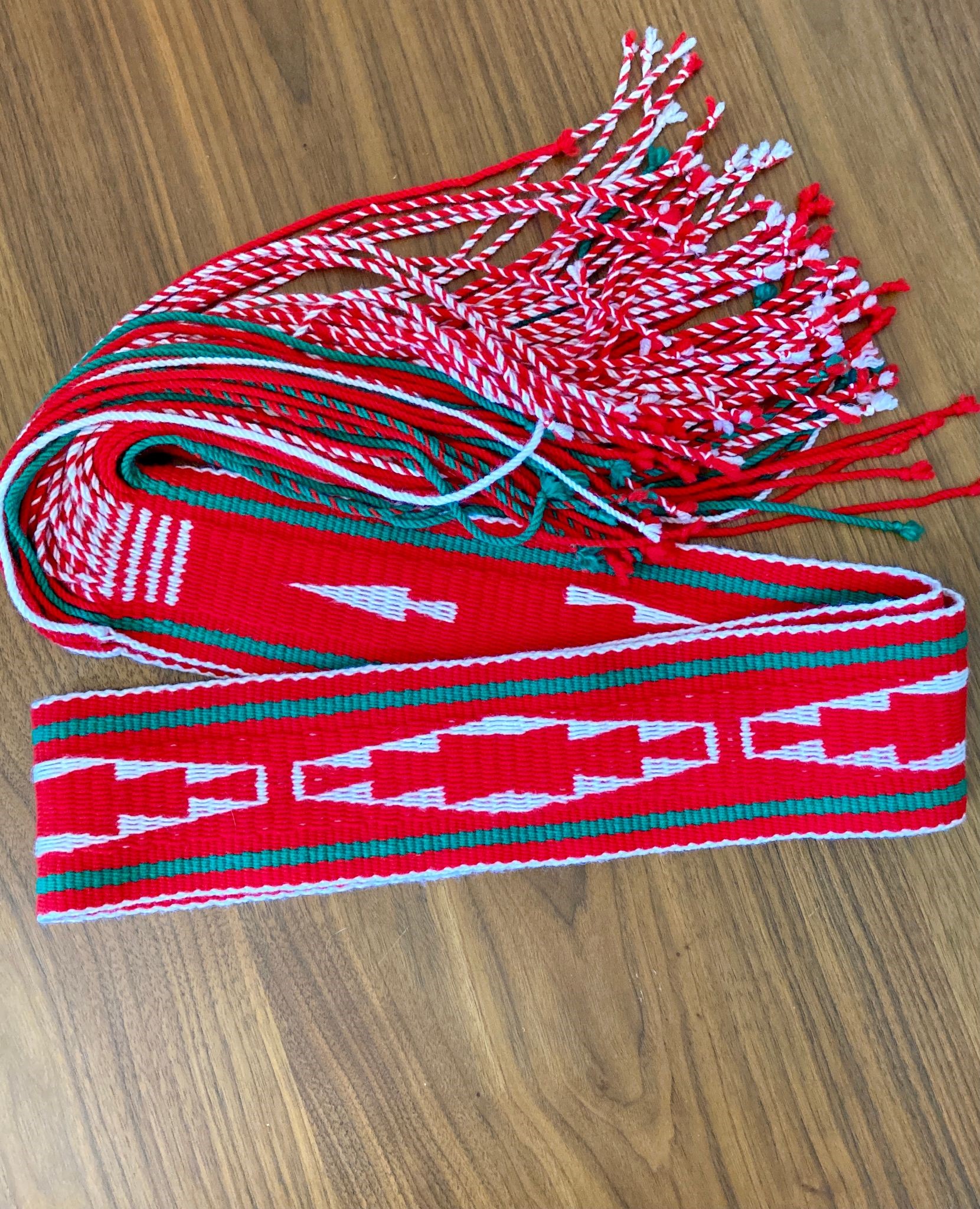A Navajo sash belt in traditional red & green colors. Photo by Emma Robbins, belt designed by Jonessa Reid
