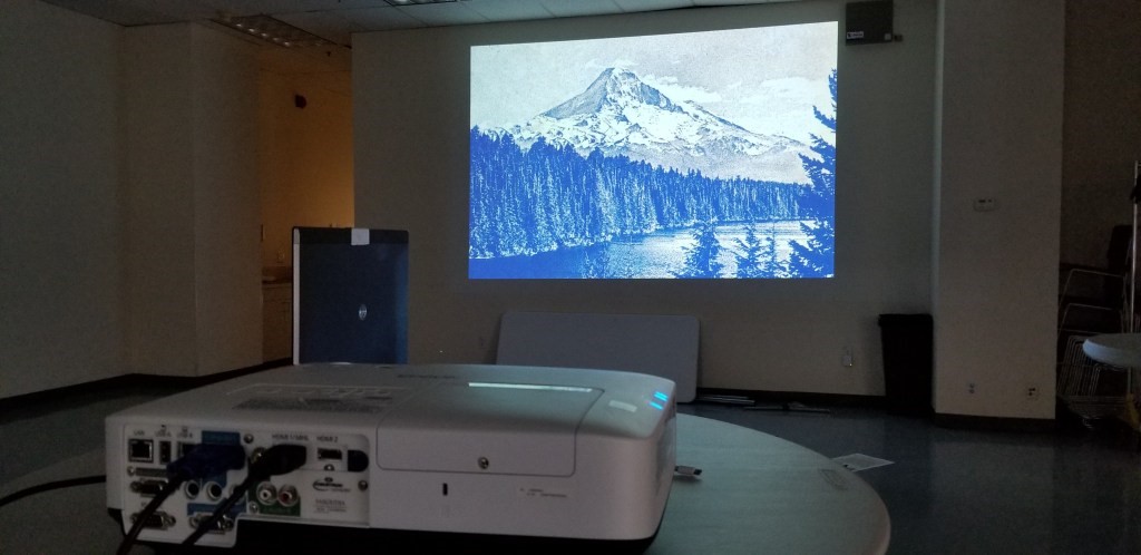 A projector shines a Pendleton advertising logo on a wall.