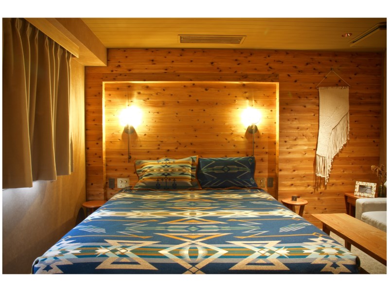A luxurious and rustic room at Hotel Unwind in Sapporo, Japan, featuring a Pendleton Star Watchers blanket.