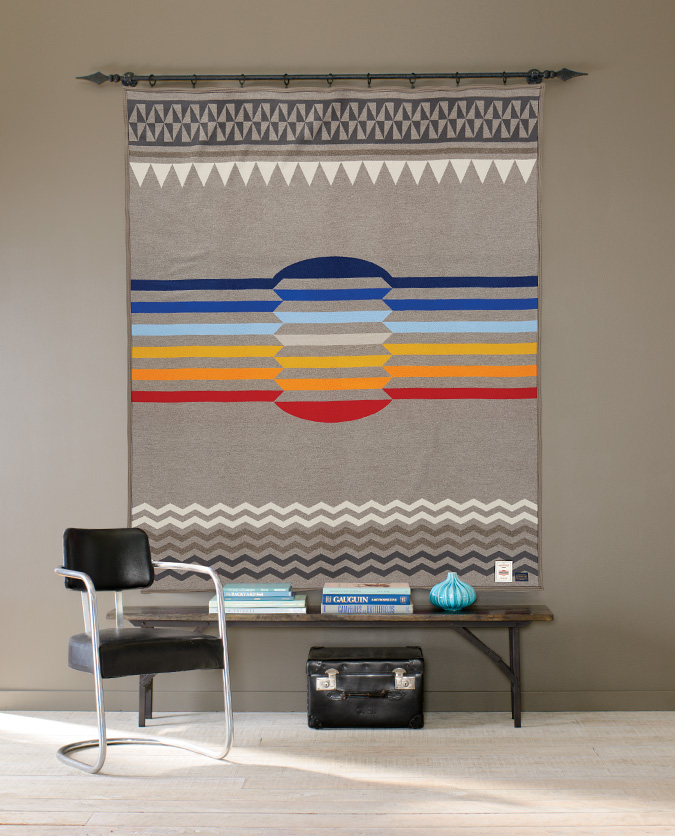 Return of the Sun blanket hanging on a wall