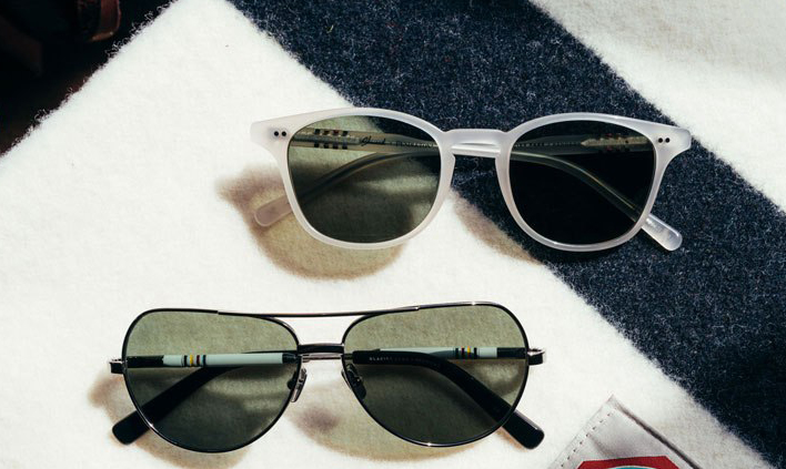 Two pairs of Pendleton x Shwood sunglasses sit on a folded Glacier National Park blanket by Pendleton.