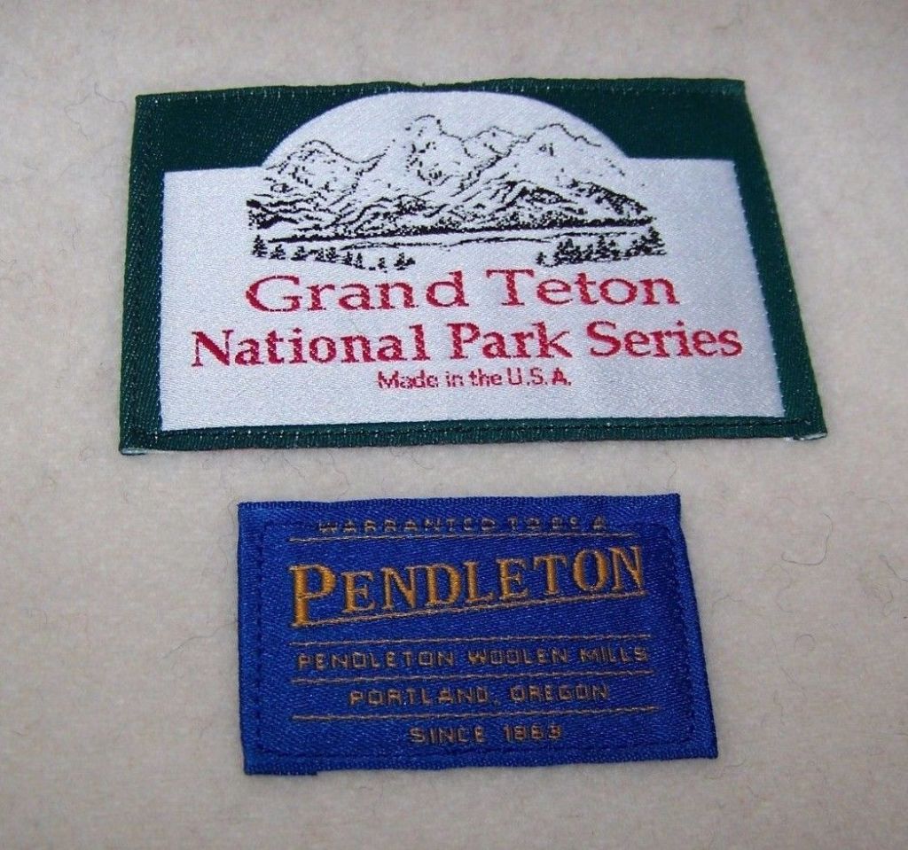A Grand Teton arched label with a 1994-2008 blue Pendleton blanket label.