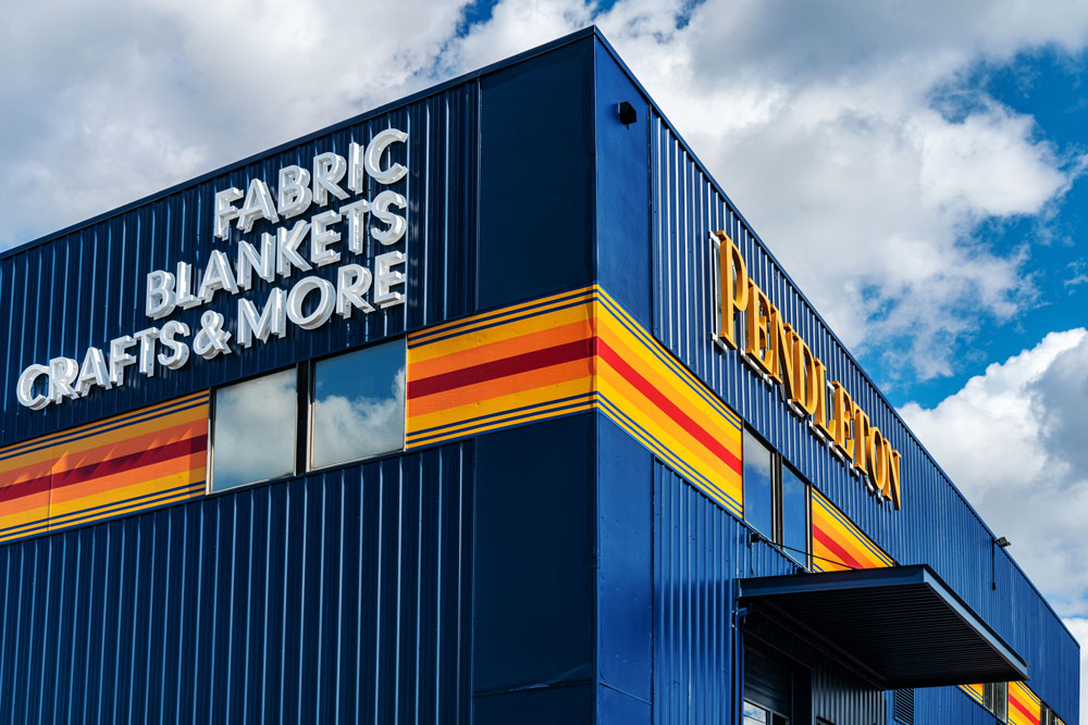 The lit signs at the Woolen Mill Store "Fabric, Blankets, Crafts & More"