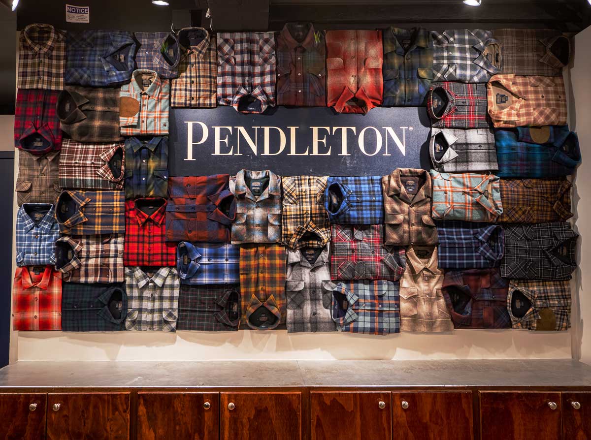 A display wall made of Pendleton plaid wool shirts.