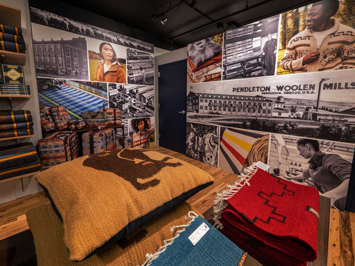A corner with bold Pendleton Mill graphics, with woven goods in the foreground