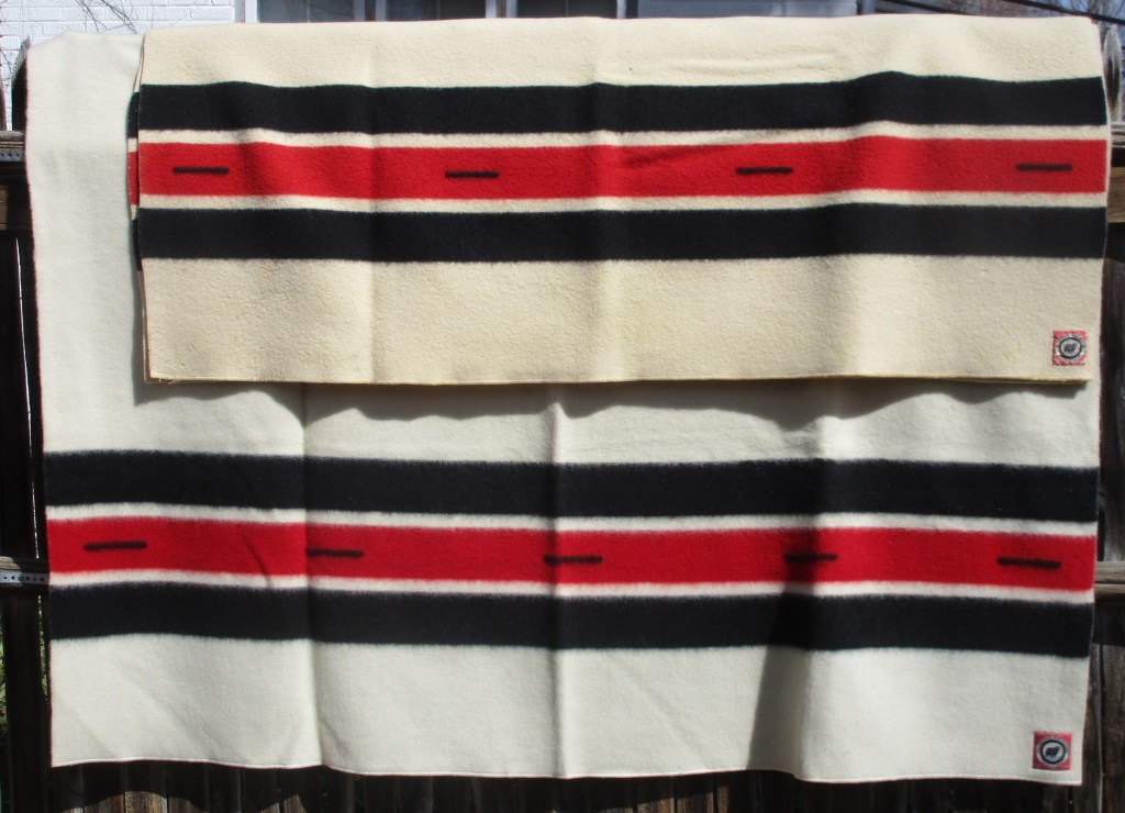 1938 Yellowstone Park Official blankets: A 4 point 66 x 84 inch Yellowstone rests on top of
a 5 point 72 x 90 inch Yellowstone, each with a bear label.