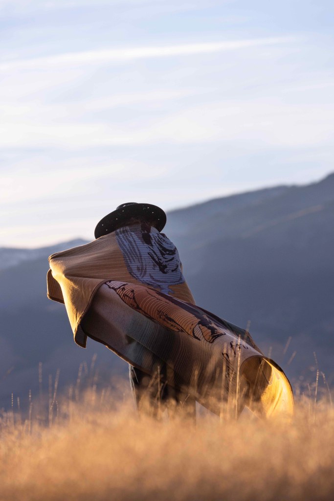 A person wrapped in the Stetson and Pendleton blanket.