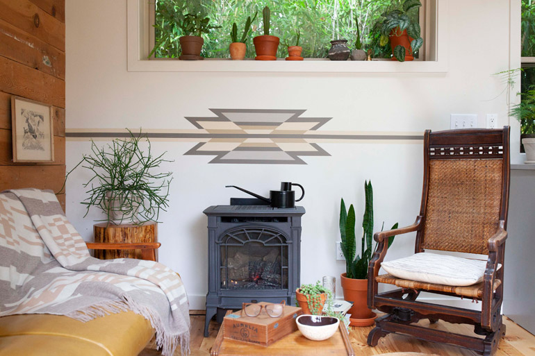 A Pacific Northwest living room in earthy neutral tones showing a painted wall motif. Photo by Oregon home magazine, used with permission.